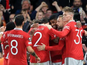 Manchester United's English striker Marcus Rashford (3R) is mobbed by teammates after scoring the team's second goal during the UEFA Europa League Group E football match between Manchester United and Sheriff Tiraspol, at Old Trafford stadium, in Manchester, north-west England, on October 27, 2022. (Photo by Lindsey Parnaby / AFP)