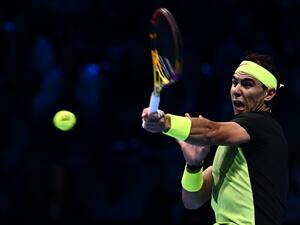 Spain's Rafael Nadal returns to USA's Taylor Fritz during their first round-robin match at the ATP Finals tennis tournament on November 13, 2022 in Turin. (Photo by MARCO BERTORELLO / AFP)