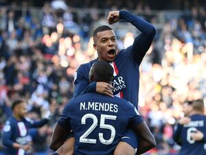 Paris Saint-Germain's French forward Kylian Mbappe (UP) celebrates with Paris Saint-Germain's Portuguese defender Nuno Mendes after scoring his team's first goal during the French L1 football match between Paris Saint-Germain FC and AJ Auxerre at the Parc des Princes stadium in Paris on November 13, 2022. (Photo by FRANCK FIFE / AFP)