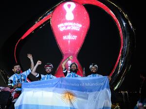 (L-R) Argentina's cyclists Matias Villarroel, Silvio Gatti, Leandro Blanco, and Lucas Ledezma pose for photos in front of the FIFA World Cup countdown clock upon arriving in Doha on November 7, 2022, ahead of the Qatar 2022 FIFA World Cup football tournament. (Photo by Kirill KUDRYAVTSEV / AFP)