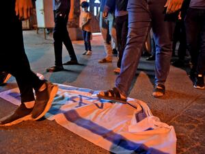 Stepping on the Israeli flag 