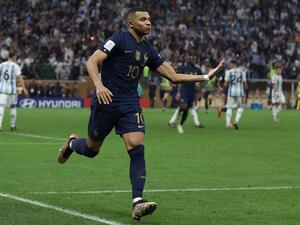 France's forward #10 Kylian Mbappe celebrates scoring his team's third goal from the penalty spot during the Qatar 2022 World Cup final football match between Argentina and France at Lusail Stadium in Lusail, north of Doha on December 18, 2022. (Photo by ADRIAN DENNIS / AFP)