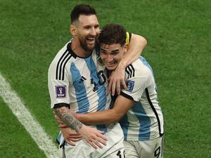 Argentina's forward #09 Julian Alvarez (R) celebrates with Argentina's forward #10 Lionel Messi after scoring his team's second goal during the Qatar 2022 World Cup football semi-final match between Argentina and Croatia at Lusail Stadium in Lusail, north of Doha on December 13, 2022. (Photo by Adrian DENNIS / AFP)