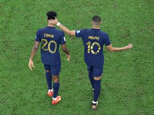 France's forward #10 Kylian Mbappe (R) consoles France's forward #20 Kingsley Coman (L) after Coman missed in the penalty shoot-out during the Qatar 2022 World Cup final football match between Argentina and France at Lusail Stadium in Lusail, north of Doha on December 18, 2022. (Photo by Giuseppe CACACE / AFP)