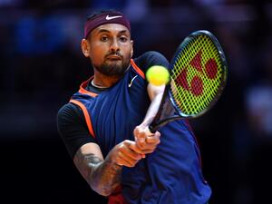 Australia's Nick Kyrgios plays the ball to Bulgaria's Grigor Dimitrov during their 2022 World Tennis League exhibition match at Dubai’s Coca-Cola arena in the United Arab Emirates, on December 21, 2022. (Photo by AFP)