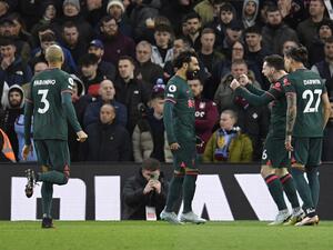Liverpool's Egyptian striker Mohamed Salah celebrates with teammates after scoring his team first goal during the English Premier League football match between Aston Villa and Liverpool at Villa Park in Birmingham, central England on December 26, 2022. (Photo by Oli SCARFF / AFP) 