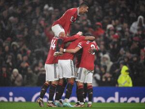 Manchester United's French striker Anthony Martial (C) celebrates with teammates after scoring his team second goal during the English Premier League football match between Manchester United and Nottingham Forest at Old Trafford in Manchester, north west England, on December 27, 2022. (Photo by Oli SCARFF / AFP)