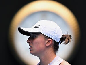 Poland's Iga Swiatek gets ready to serve against Kazakhstan's Elena Rybakina during their women's singles match on day seven of the Australian Open tennis tournament in Melbourne on January 22, 2023. (Photo by Manan VATSYAYANA / AFP)