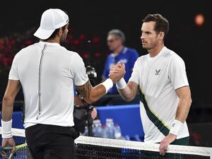 Britain's Andy Murray (R) shakes hands Italy's Matteo Berrettini after their men's singles match on day two of the Australian Open tennis tournament in Melbourne on January 17, 2023. (Photo by Paul CROCK / AFP)