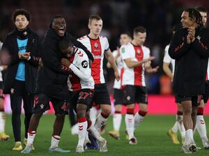 Southampton's Belgian midfielder Romeo Lavia (2L) and Southampton's French midfielder Ibrahima Diallo (3L) celebrate with Southampton's French striker Sekou Mara (R) after the English League Cup quarter-final football match between Southampton and Manchester City at St Mary's Stadium in Southampton, southern England on January 11, 2023. - Southampton won the match 2-0. (Photo by ADRIAN DENNIS / AFP)