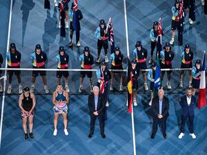 Winner Belarus' Aryna Sabalenka (2L) and Kazakhstan's Elena Rybakina (L) wait for the podium ceremony during the women's singles final on day thirteen of the Australian Open tennis tournament in Melbourne on January 28, 2023. (Photo by Paul CROCK / AFP)
