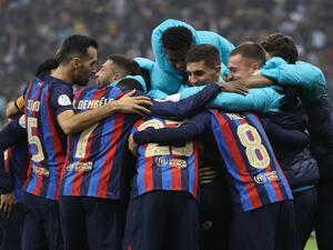 Barcelona's Spanish midfielder Pedri celebrates with teammates after scoring his team's third goal during the Spanish Super Cup final football match between Real Madrid CF and FC Barcelona at the King Fahd International Stadium in Riyadh, Saudi Arabia, on January 15, 2023. (Photo by Giuseppe CACACE / AFP)