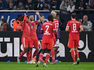 Bayern Munich's players celebrate after German midfielder Serge Gnabry (L) scored his team's first goal during the German first division Bundesliga football match between Schalke 04 v Bayern Munich in Gelsenkirchen, western Germany, on November 12, 2022. (Photo by UWE KRAFT / AFP) 
