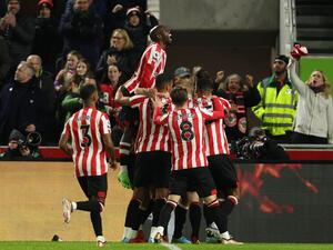 Brentford players celebrate after an own goal from Liverpool's French defender Ibrahima Konate gives them the lead during the English Premier League football match between Brentford and Liverpool at Gtech Community Stadium in London on January 2, 2023. (Photo by Adrian DENNIS / AFP)