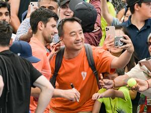 Serbian tennis player Novak Djokovic has a selfie with a fan after his first round doubles match with Canadian Vasek Pospisil at the ATP Adelaide International tournament in Adelaide on January 2, 2023. (Photo by Brenton EDWARDS / AFP)
