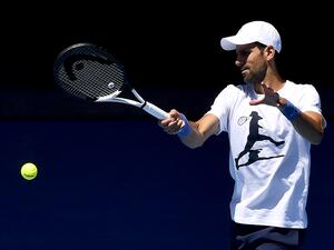 Serbia's Novak Djokovic hits a return during a practice session ahead of the Australian Open tennis tournament in Melbourne on January 14, 2023. (Photo by Paul CROCK / AFP)
