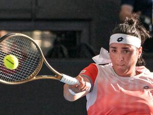 Tunisia's Ons Jabeur hits a return against Ukraine's Marta Kostyuk during their women's singles quarter-final match at the Adelaide International tennis tournament in Adelaide on January 6, 2023. (Photo by Brenton EDWARDS / AFP)