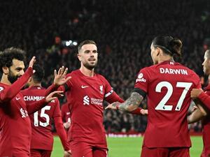 Liverpool's teammates celebrate the second owngoal scored by Leicester City's Belgian defender Wout Faes during the English Premier League football match between Liverpool and Leicester City at Anfield in Liverpool, north west England on December 30, 2022. (Photo by Oli SCARFF / AFP) 
