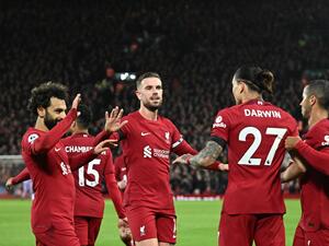 Liverpool's teammates celebrate the second owngoal scored by Leicester City's Belgian defender Wout Faes during the English Premier League football match between Liverpool and Leicester City at Anfield in Liverpool, north west England on December 30, 2022. (Photo by Oli SCARFF / AFP)
