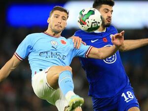Manchester City's Portuguese defender Ruben Dias (L) vies with Chelsea's Albanian forward Armando Broja (R) during the English League Cup third round football match between Manchester City and Chelsea at the Etihad stadium in Manchester, northwest England on November 9, 2021. (Photo by Lindsey Parnaby / AFP) 
