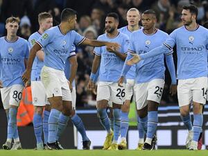 Manchester City's Algerian midfielder Riyad Mahrez (C) celebrates scoring the team's second goal during the English League Cup fourth round football match between Manchester City and Liverpool, at the Etihad stadium in Manchester on December 22, 2022. (Photo by Oli SCARFF / AFP) 