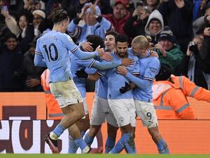 Manchester City's Algerian midfielder Riyad Mahrez (2R) celebrates scoring the team's third goal with Manchester City's Norwegian striker Erling Haaland (R) during the English Premier League football match between Manchester City and Tottenham Hotspur at the Etihad Stadium in Manchester, north west England, on January 19, 2023. (Photo by Oli SCARFF / AFP)