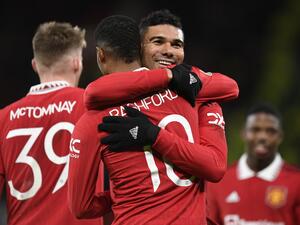 Manchester United's English striker Marcus Rashford celebrates with Manchester United's Brazilian midfielder Casemiro after scoring their third goal during the English League Cup quarter final football match between Manchester United and Charlton Athletic, at Old Trafford, in Manchester, north-west England on January 10, 2023. - Man Utd won the game 3-0. (Photo by Oli SCARFF / AFP)