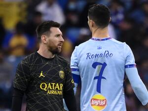 Paris Saint-Germain's Argentine forward Lionel Messi (L) walks past Riyadh All-Star's Portuguese forward Cristiano Ronaldo (R) during the Riyadh Season Cup football match between the Riyadh All-Stars and Paris Saint-Germain at the King Fahd Stadium in Riyadh on January 19, 2023. (Photo by FRANCK FIFE / AFP)