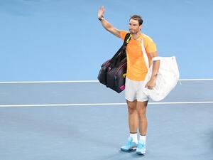 Spain's Rafael Nadal waves as he leaves after his men's singles against Mackenzie McDonald of the US on day three of the Australian Open tennis tournament in Melbourne on January 18, 2023. Defending champion and top seed Rafael Nadal crashed out of the Australian Open in round two to 65th-ranked American Mackenzie McDonald in a major upset Wednesday, his worst Grand Slam result in seven years. (Photo by Martin KEEP / AFP)