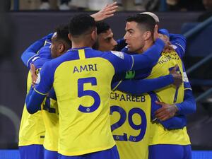 Nassr's Portuguese forward Cristiano Ronaldo celebrates with teammates after they scored their first goal during the Saudi Pro League football match between Al-Nassr and Al-Ettifaq at the King Fahd Stadium in the Saudi capital Riyadh on January 22, 2023. (Photo by Fayez NURELDINE / AFP)