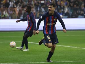 Barcelona's Spanish midfielder Pedri celebrates after scoring his team's third goal during the Spanish Super Cup final football match between Real Madrid CF and FC Barcelona at the King Fahd International Stadium in Riyadh, Saudi Arabia, on January 15, 2023. (Photo by Giuseppe CACACE / AFP)