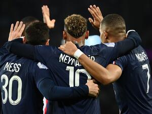 Paris Saint-Germain's Brazilian forward Neymar (C) celebrates after opening the scoring with Paris Saint-Germain's Argentine forward Lionel Messi (L) and Paris Saint-Germain's French forward Kylian Mbappe during the French L1 football match between Paris Saint-Germain (PSG) and Olympique de Marseille (OM) at the Parc des Princes Stadium in Paris, on October 16, 2022. (Photo by FRANCK FIFE / AFP)