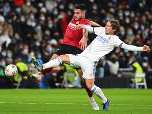Valencia's Spanish defender Hugo Guillamon (L) vies with Real Madrid's Croatian midfielder Luka Modric during the Spanish league football match between Real Madrid CF and Valencia CF at the Santiago Bernabeu stadium in Madrid on January 8, 2022. (Photo by GABRIEL BOUYS / AFP)
