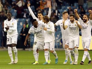 Real Madrid's players celebrate after winning the Spanish Super Cup semi-final football match between Real Madrid CF and Valencia CF at the King Fahd International Stadium in Riyadh, Saudi Arabia, on January 11, 2023. (Photo by Giuseppe CACACE / AFP)