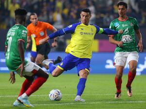 Nassr's Portuguese forward Cristiano Ronaldo (C) attempts a shot during the Saudi Pro League football match between Al-Nassr and Al-Ettifaq at the King Fahd Stadium in the Saudi capital Riyadh on January 22, 2023. (Photo by Fayez NURELDINE / AFP)
