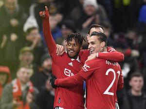 Manchester United's Brazilian midfielder Fred (L) celebrates with teammates after scoring their third goal during the English FA Cup fourth round football match between Manchester United and Reading at Old Trafford in Manchester, north west England, on January 28, 2023. (Photo by Oli SCARFF / AFP)