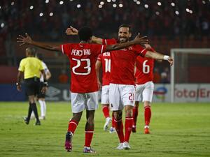 Ahly's forward Percy Tau (L) celebrates with Ahly's defender Ali Maaloul after scoring the fourth goal during the CAF Champions League semi-final match between Egypt's al-Ahly and Algeria's ES Setif at the al-Salam stadium in Cairo on May 7, 2022. (Photo by Khaled DESOUKI / AFP)