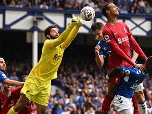 Liverpool's Brazilian goalkeeper Alisson Becker punches the ball clear during the English Premier League football match between Everton and Liverpool at Goodison Park in Liverpool, north west England on September 3, 2022. (Photo by Oli SCARFF / AFP) 