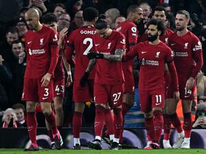Liverpool's Egyptian striker Mohamed Salah (3R) celebrates scoring the opening goal during the English Premier League football match between Liverpool and Everton at Anfield in Liverpool, north west England on February 13, 2023. (Photo by Paul ELLIS / AFP)