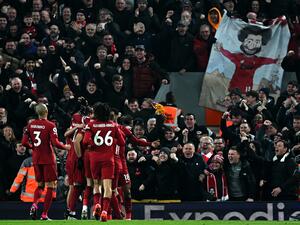 Liverpool's Egyptian striker Mohamed Salah is mobbed by teammates after scoring the opening goal during the English Premier League football match between Liverpool and Everton at Anfield in Liverpool, north west England on February 13, 2023. (Photo by Paul ELLIS / AFP)