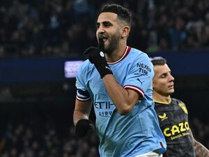 Manchester City's Algerian midfielder Riyad Mahrez celebrates after scoring their third goal from the penalty spot during the English Premier League football match between Manchester City and Aston Villa at the Etihad Stadium in Manchester, north west England, on February 12, 2023. (Photo by Paul ELLIS / AFP)
