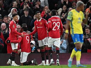 Manchester United's French striker Anthony Martial (2L) celebrates scoring the opening goal with Manchester United's English striker Jadon Sancho (L)during the English League Cup semi-final second-leg football match between Manchester United and Nottingham Forest at Old Trafford in Manchester, north west England, on February 1, 2023. (Photo by Paul ELLIS / AFP)