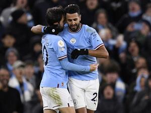 Manchester City's Algerian midfielder Riyad Mahrez (R) celebrates scoring the team's fourth goal during the English Premier League football match between Manchester City and Tottenham Hotspur at the Etihad Stadium in Manchester, north west England, on January 19, 2023. (Photo by Oli SCARFF / AFP)