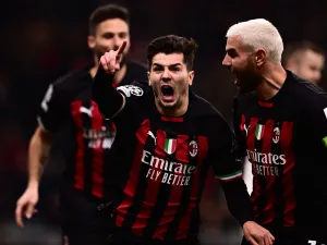 AC Milan's Spanish midfielder Brahim Diaz (C) celebrates with AC Milan's French defender Theo Hernandez after opening the scoring during the UEFA Champions League round of 16, first leg football match between AC Milan and Tottenham Hotspur on February 14, 2023 at the San Siro stadium in Milan. (Photo by Marco BERTORELLO / AFP)