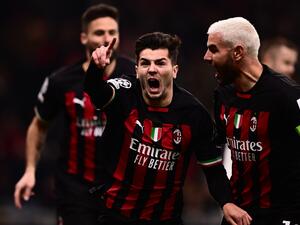 AC Milan's Spanish midfielder Brahim Diaz (C) celebrates with AC Milan's French defender Theo Hernandez after opening the scoring during the UEFA Champions League round of 16, first leg football match between AC Milan and Tottenham Hotspur on February 14, 2023 at the San Siro stadium in Milan. (Photo by Marco BERTORELLO / AFP)