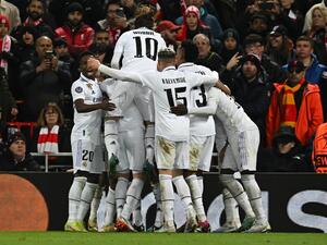 Real Madrid's French forward Karim Benzema is mobbed by teammates after scoring the team's third goal during the UEFA Champions League last 16 first leg football match between Liverpool and Real Madrid at Anfield in Liverpool, north west England on February 21, 2023. (Photo by Paul ELLIS / AFP)