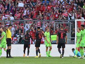 Bayern Munich's German midfielder Jamal Musiala (C) celebrates with team mates his 1-0 during the German first division Bundesliga football match between FC Bayern Munich and VfL Wolfsburg in Munich, southern Germany on August 14, 2022. (Photo by KERSTIN JOENSSON / AFP)