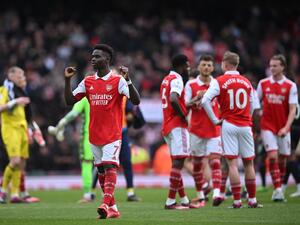 Arsenal's English midfielder Bukayo Saka gestures to fans on the pitch after the English Premier League football match between Arsenal and Crystal Palace at the Emirates Stadium in London on March 19, 2023. Arsenal won the game 4-1. (Photo by JUSTIN TALLIS / AFP)