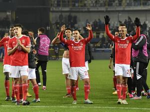Benfica's players celebrate their victory at the end of the UEFA Champions League round of sixteen first leg football match between Bruges (Club Brugge) and Benfica Lisbon at Jan-Breydel Stadion in Bruges, on February 15, 2023. (Photo by JOHN THYS / AFP)