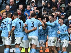 Manchester City's Portuguese midfielder Bernardo Silva (C) celebrates with teammates after scoring their second goal during the English Premier League football match between Manchester City and Newcastle United at the Etihad Stadium in Manchester, north west England, on March 4, 2023. (Photo by Paul ELLIS / AFP) 